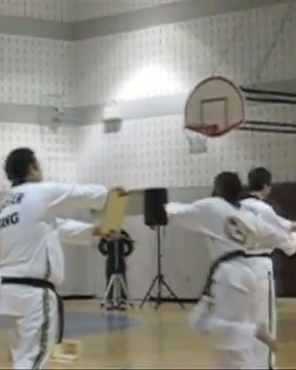 Fuad Kamal mid-strike, breaking a board